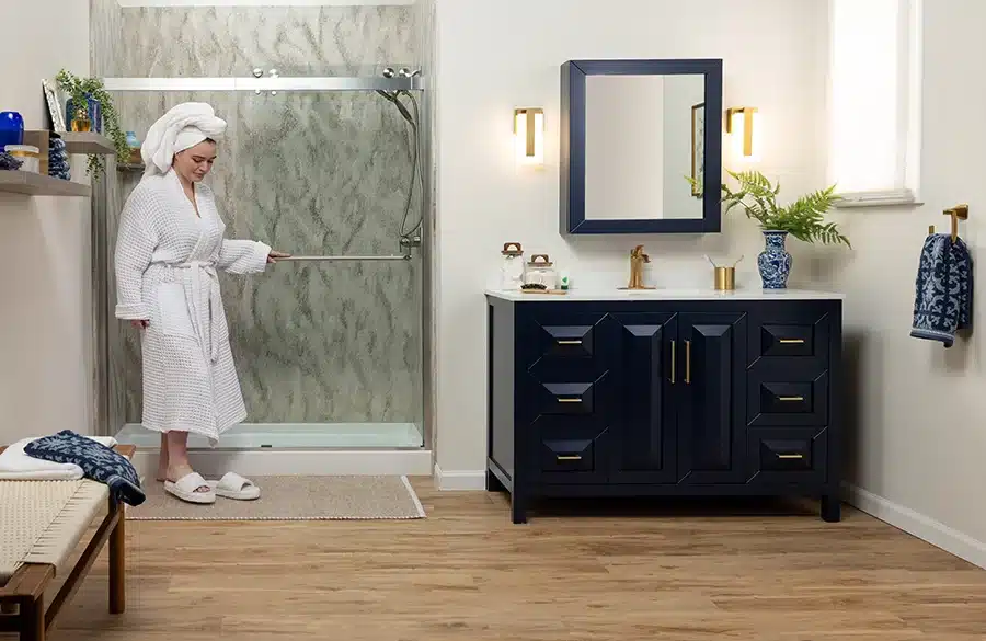 Woman in bathrobe steps out of shower in a modern bathroom remodeled by Earl's Plumbing in Lubbock, TX
