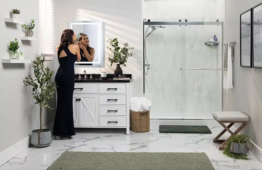 Woman in formal gown gets ready in a modern bathroom remodeled by Earl's Plumbing in Lubbock, TX